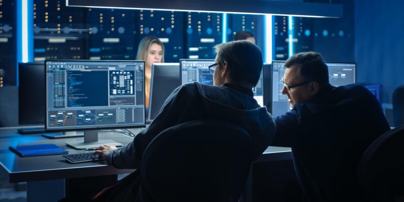 Team of IT Programers Working on Desktop Computers in Data Center Control Room. Team of Young Professionals Working In Software and Hardware Development, Doing Coding